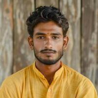 portrait-of-a-pleasant-looking-man-of-indian-origin-against-a-wooden-background-photo